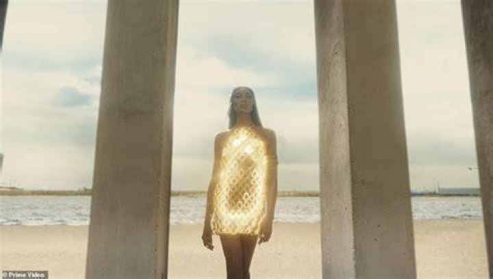 Radiant: She wore a long veil which flowed down the back of her dress and pinned her blonde tresses back in a chic up do while opting for glowing makeup